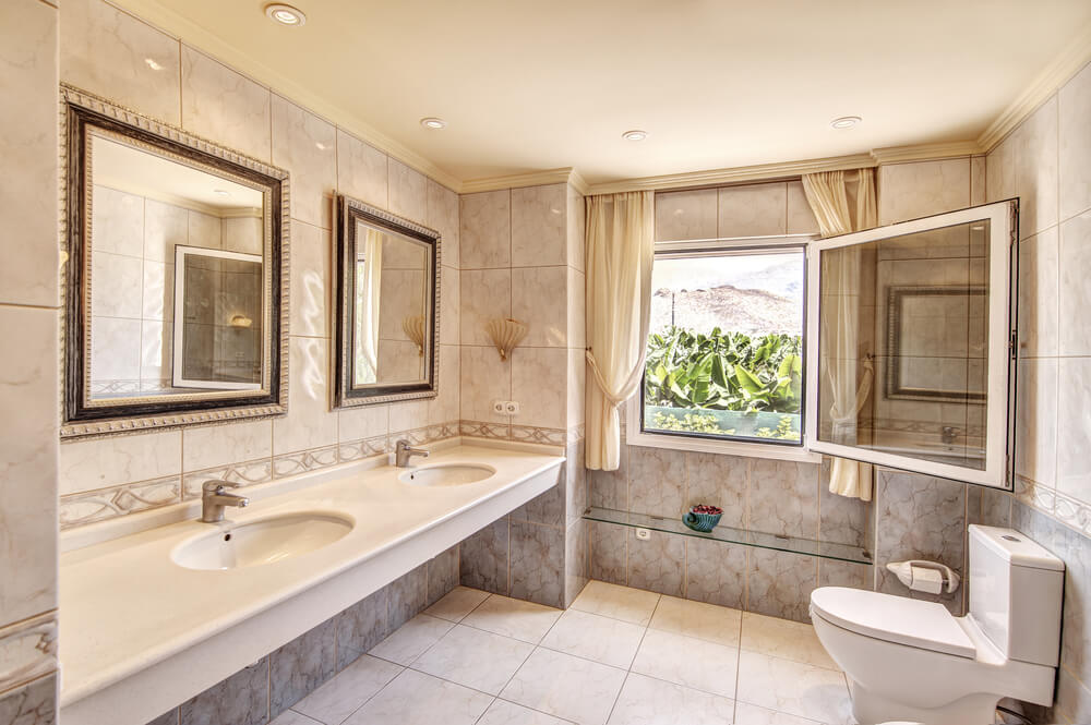 Tile from floor to ceiling, with two mirrors with matching frames adds a hint or richness.