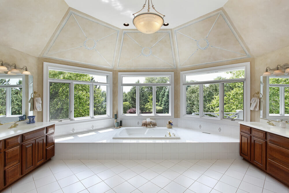 This traditional styled bathroom has two cabinets for storage and the tub as the center piece.