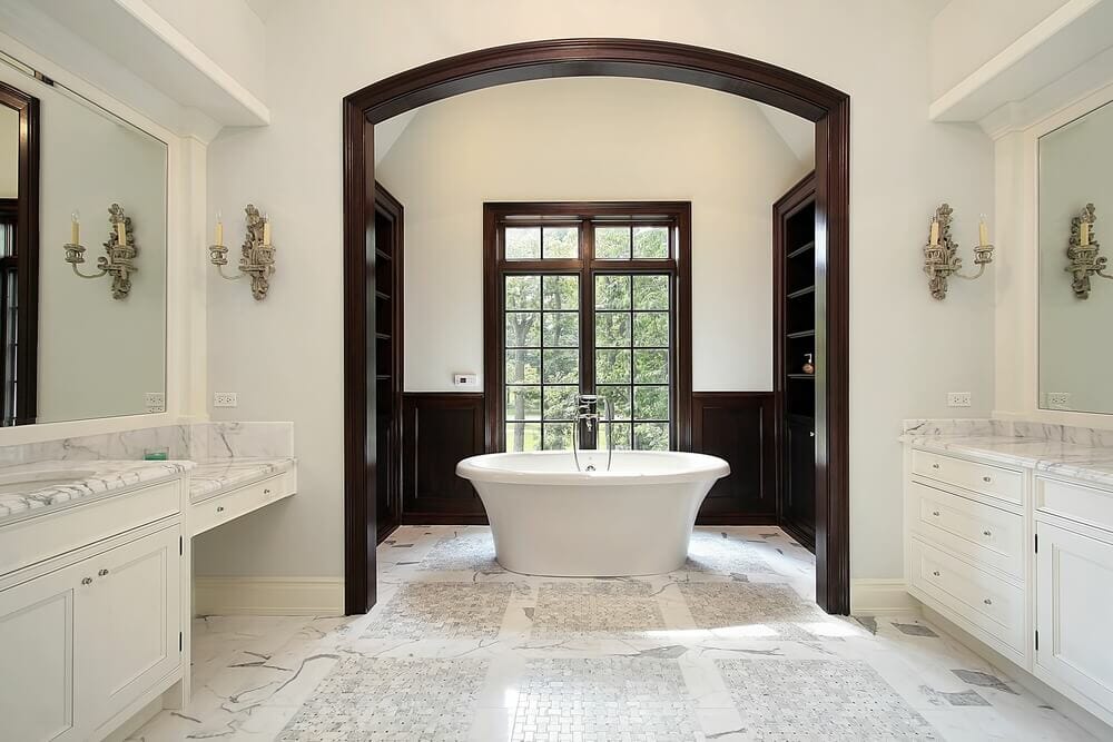 Simple design yet full of details. From the wood trim to the marble flooring this bathroom says luxury.